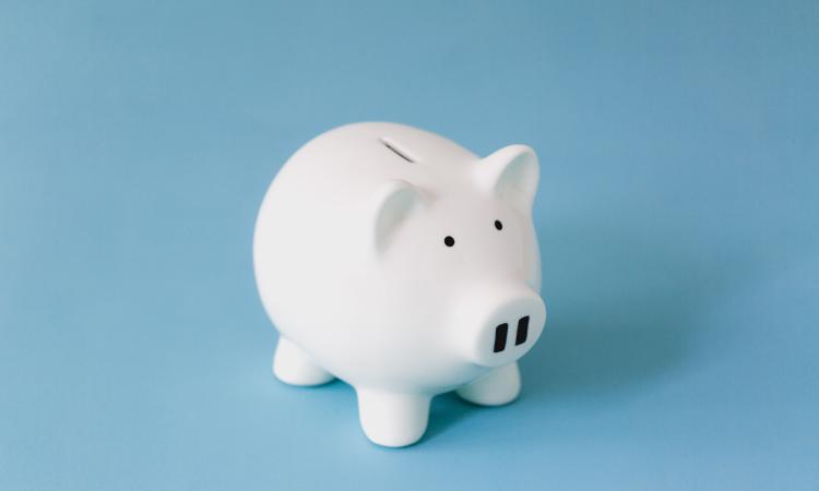 White piggy bank for collecting money on a blue background