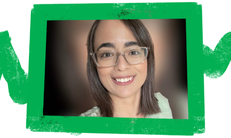 Huma smiling at the camera with a green frame around the image