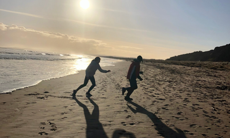 Two people playing a game on the beach